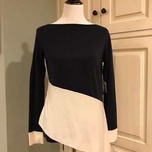 Navy sweater with white asymmetrical detail.